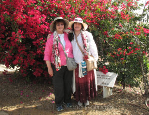 Sheryl & L. Eilee in front of floral bush at Mt. of Beatitudes