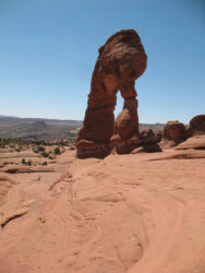 Digital photo of Arches Natural Park's Delicate Arch, from an odd angle at the edge of a massive dropoff; I was crazy to take this photo from here! © 2012 L. Eilee S. George
