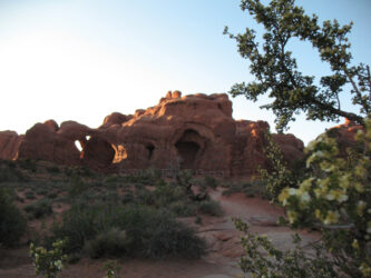 Digital photo in Arches Natural Park, a nice detail of a triple arch and adjacent formations with flowers in the foreground © 2012 L. Eilee S. George