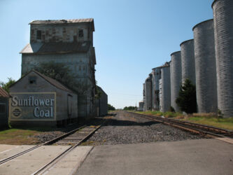 Digital photograph of railroad tracks, silos and a building painted with an advertisement for Sunflower Coal, located in Wilson, KS photo © 2009 Linda Eileen "Eilee" Spaeth George