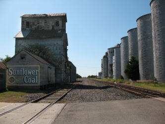 Digital photograph of railroad tracks, silos and a building painted with an advertisement for Sunflower Coal, located in Wilson, KS photo © 2009 Linda Eileen "Eilee" Spaeth George