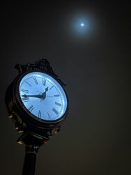 Clock in Old Town Arvada with moon © 2022 L. Eilee S. George