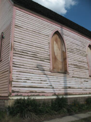 Boarded up church in Leadville CO with shadow of light pole reiterating that lights are out © 2017 L. Eilee S. George